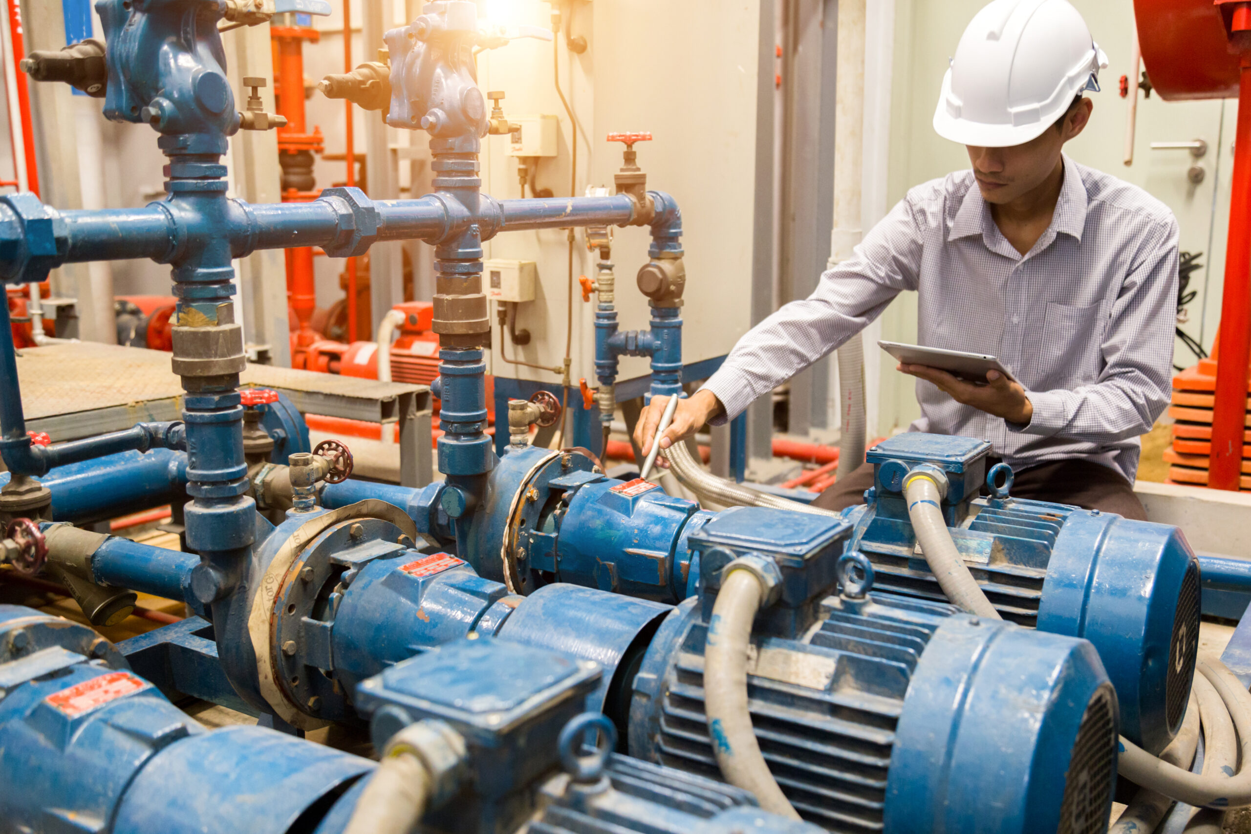 Asian engineer maintenance checking technical data of system eq